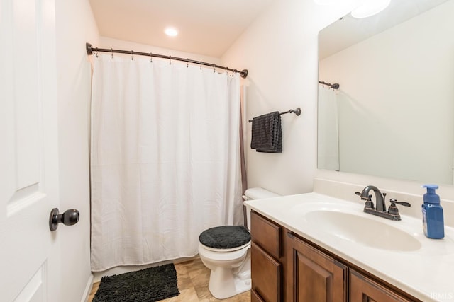 bathroom featuring vanity and toilet