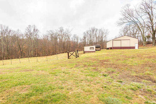 view of yard with an outbuilding and a rural view