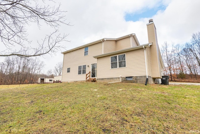 back of property featuring a lawn