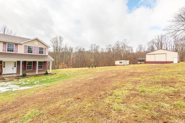 view of yard with an outbuilding and covered porch