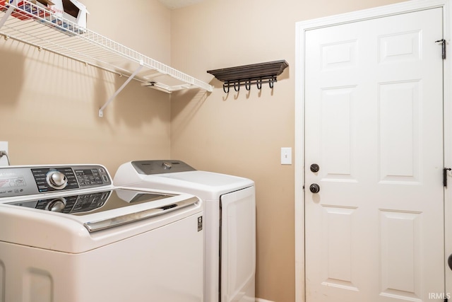 clothes washing area featuring washer and clothes dryer