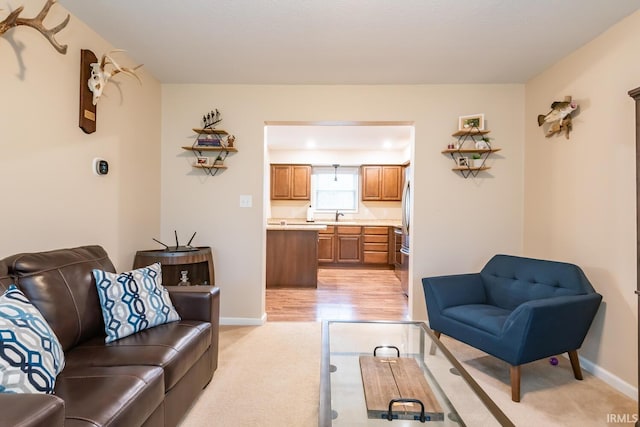 living room with sink and light colored carpet