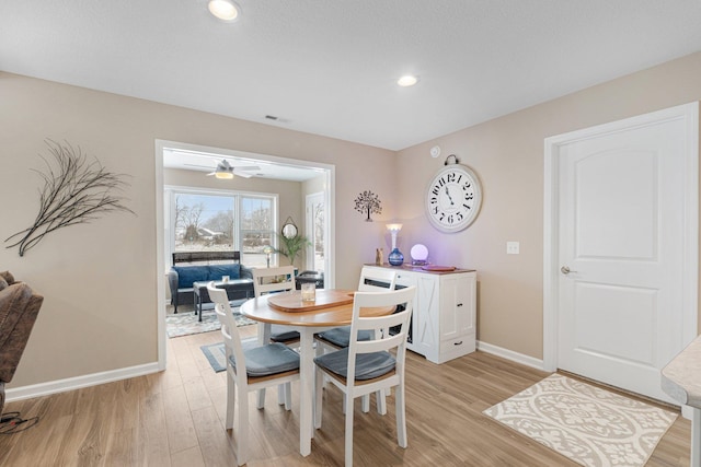 dining area featuring ceiling fan and light hardwood / wood-style floors