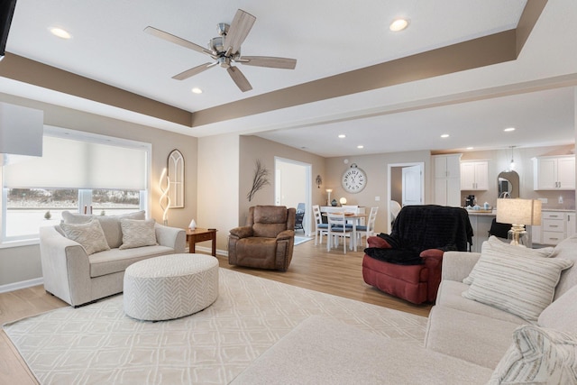 living room with ceiling fan and light wood-type flooring