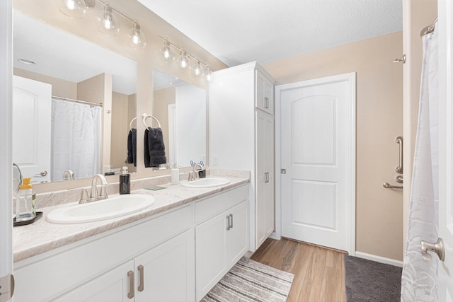 bathroom featuring hardwood / wood-style flooring and vanity