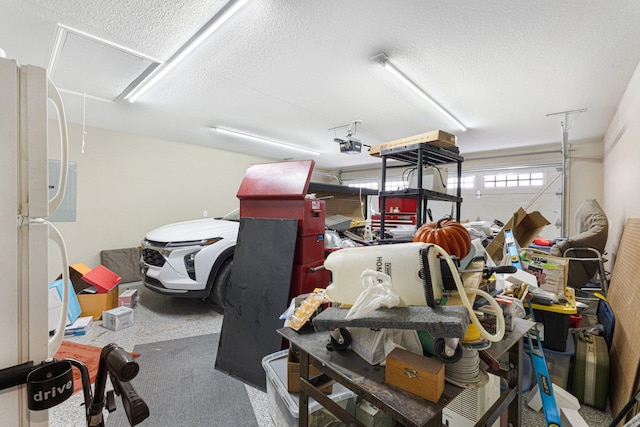 garage featuring a garage door opener and white fridge