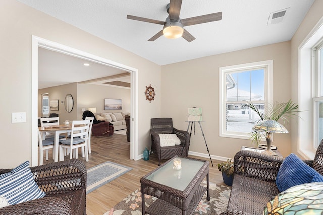 living room with ceiling fan and light hardwood / wood-style floors