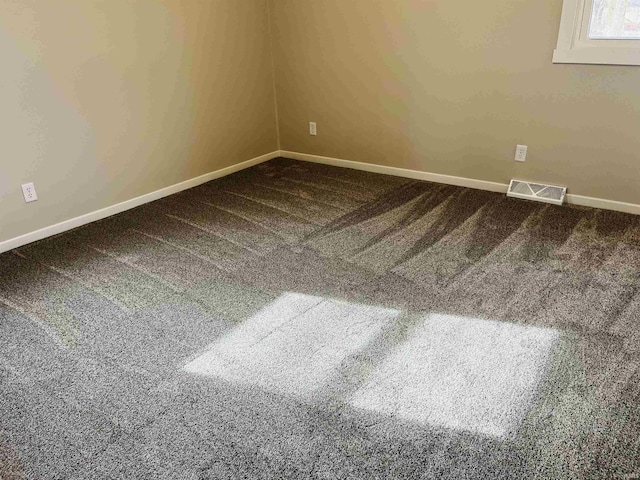 empty room featuring carpet flooring