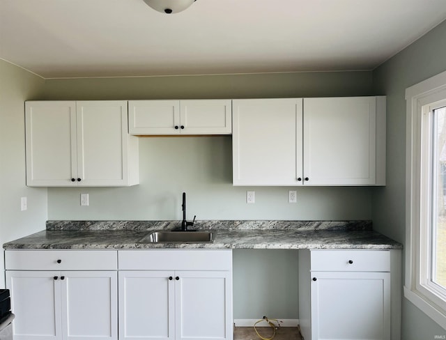 kitchen with white cabinetry, sink, and a healthy amount of sunlight