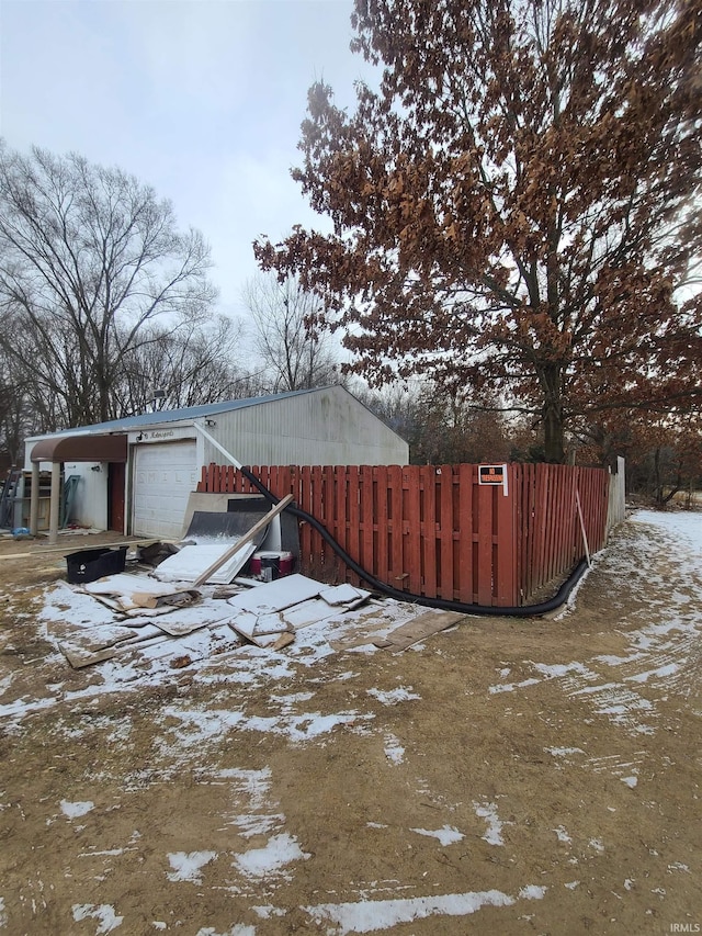 yard covered in snow featuring a garage