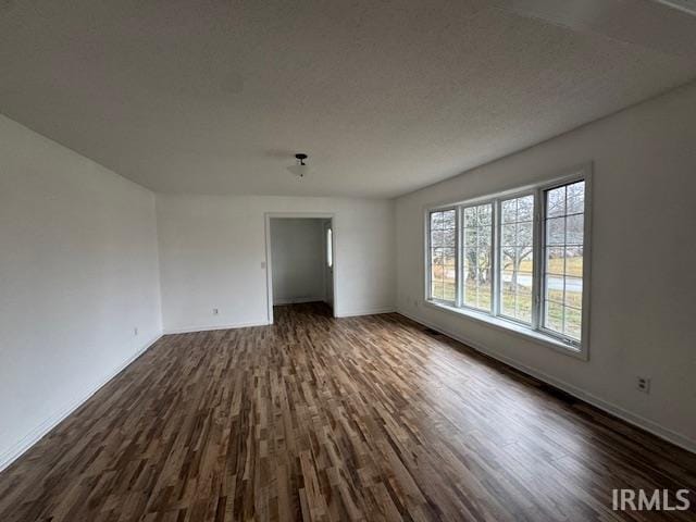 empty room with dark wood-type flooring