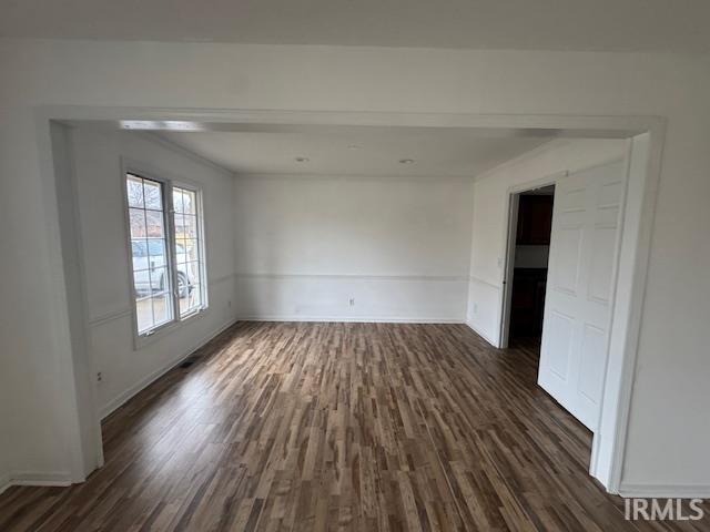 unfurnished room featuring dark hardwood / wood-style flooring