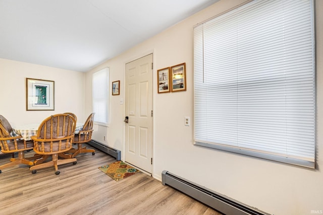 interior space with baseboard heating and light hardwood / wood-style floors