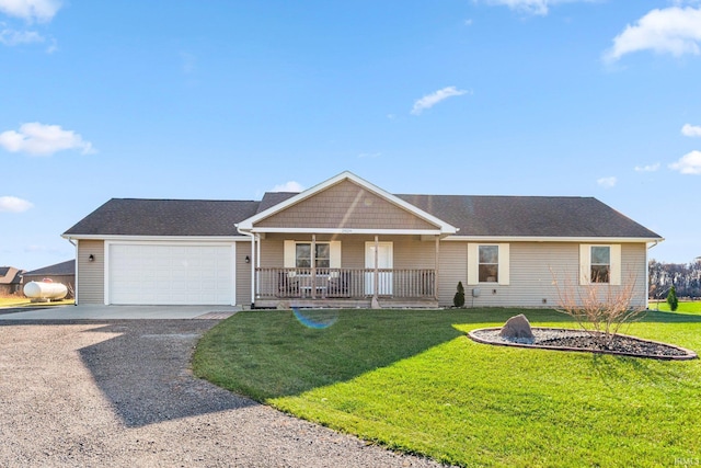 ranch-style home featuring a porch, a garage, and a front yard