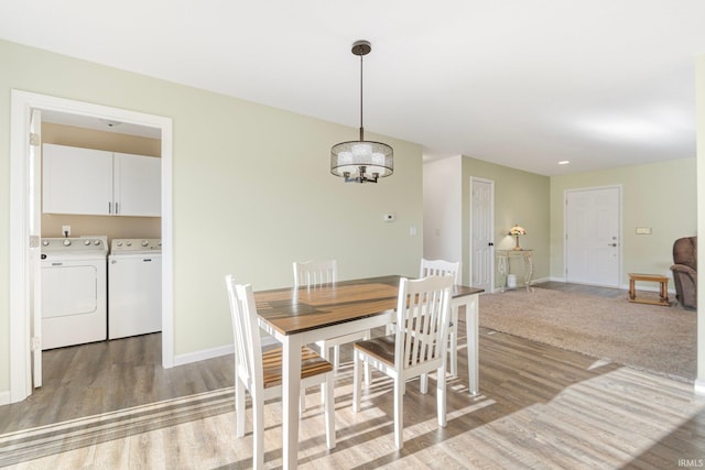 dining space featuring hardwood / wood-style flooring and washer and clothes dryer