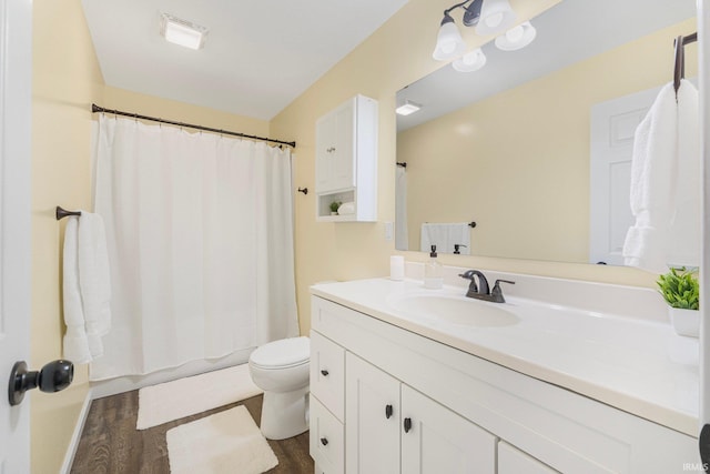 bathroom with vanity, hardwood / wood-style floors, and toilet