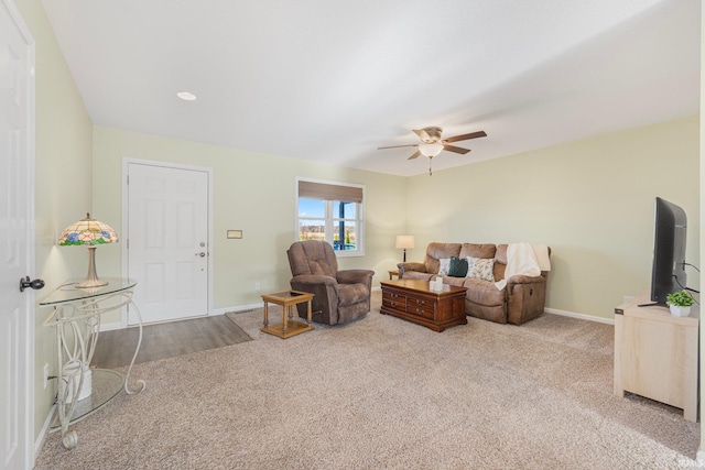 carpeted living room with ceiling fan