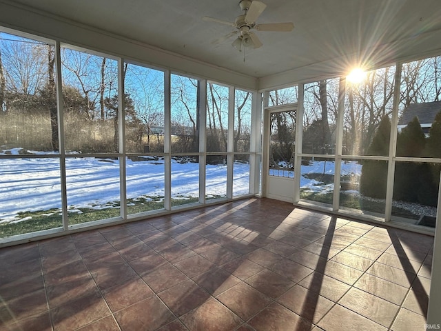 unfurnished sunroom with ceiling fan