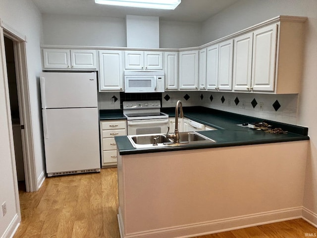 kitchen with sink, white appliances, white cabinets, and light wood-type flooring