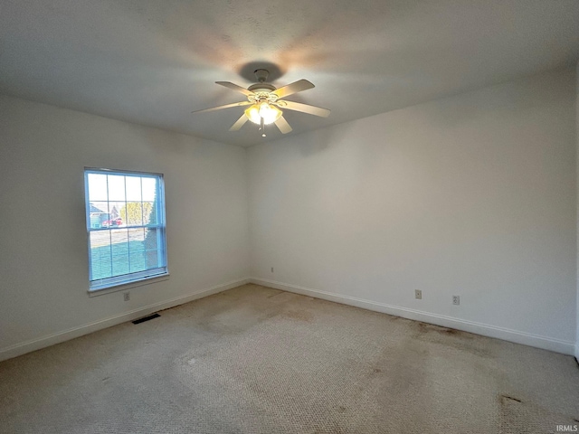 unfurnished room featuring light colored carpet and ceiling fan