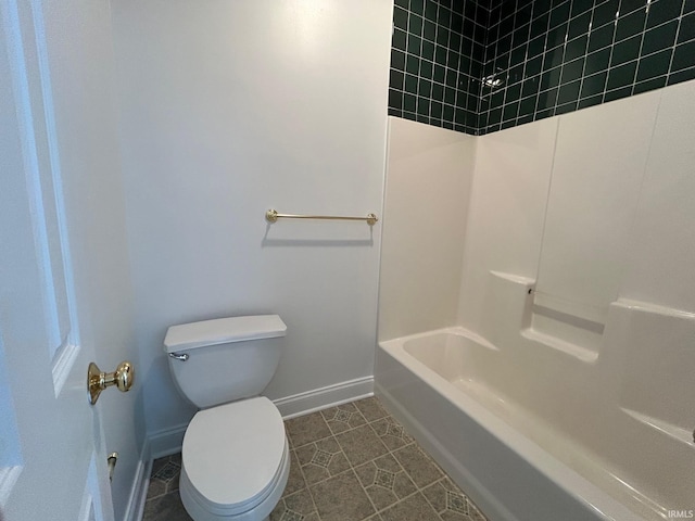 bathroom featuring washtub / shower combination, toilet, and tile patterned flooring