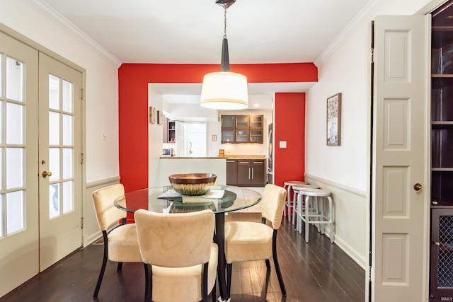 dining area with dark hardwood / wood-style floors, a wealth of natural light, ornamental molding, and french doors