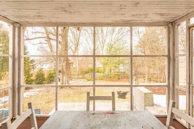 unfurnished sunroom featuring wood ceiling