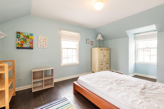 bedroom with dark hardwood / wood-style floors, vaulted ceiling, and multiple windows