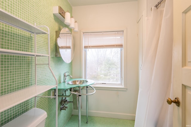 bathroom featuring toilet, tile patterned flooring, and a shower with shower curtain