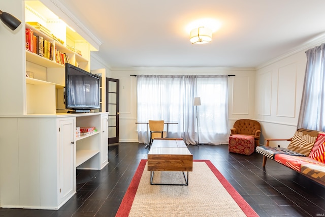 living room featuring dark hardwood / wood-style flooring and ornamental molding