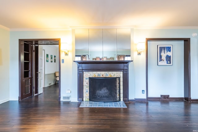 unfurnished living room featuring crown molding, a fireplace, dark hardwood / wood-style floors, and built in features