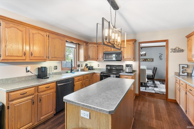 kitchen featuring sink, decorative light fixtures, dark hardwood / wood-style floors, a kitchen island, and black appliances