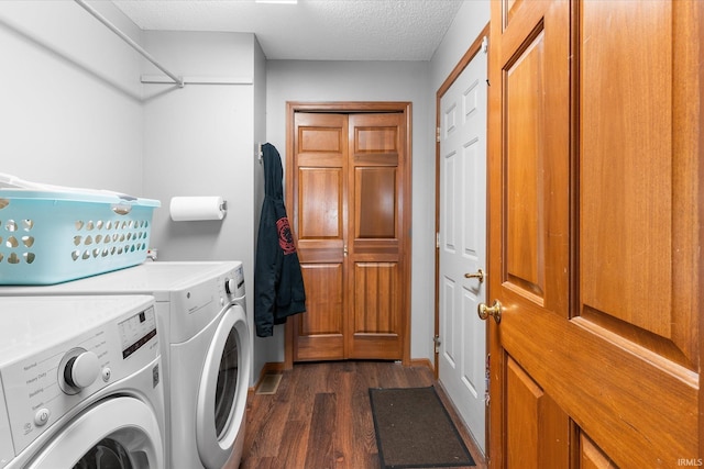 laundry room with separate washer and dryer, dark hardwood / wood-style floors, and a textured ceiling