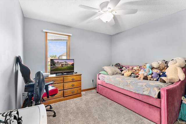 bedroom featuring ceiling fan, carpet floors, and a textured ceiling