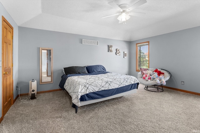 carpeted bedroom with ceiling fan and a textured ceiling