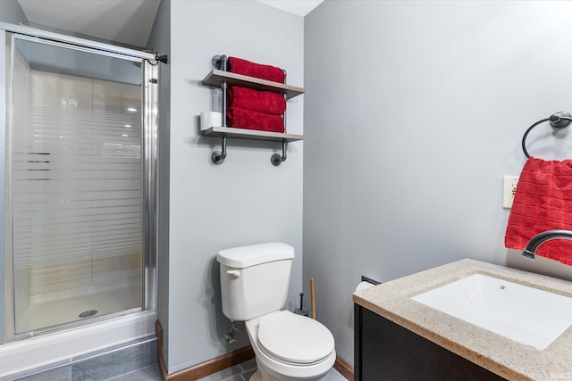 bathroom featuring vanity, a shower with shower door, and toilet