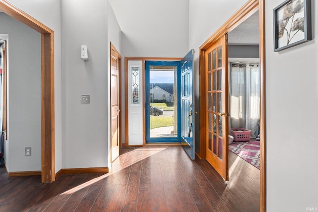 foyer with dark hardwood / wood-style flooring and french doors