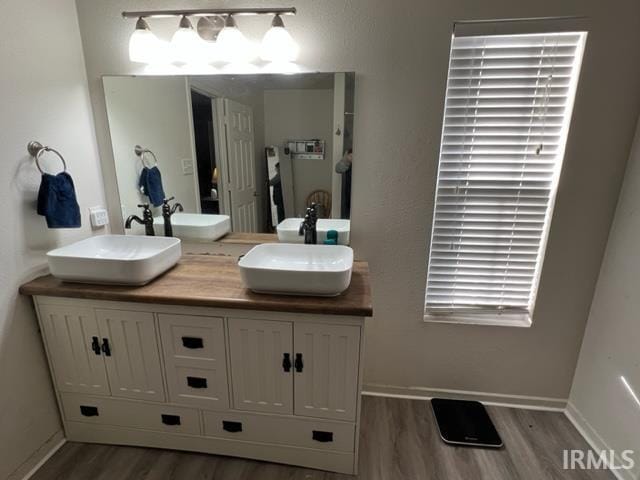 bathroom with vanity and hardwood / wood-style floors