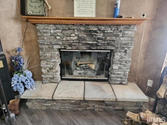 room details featuring a fireplace and hardwood / wood-style floors