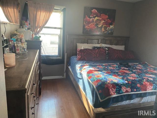 bedroom featuring dark hardwood / wood-style flooring