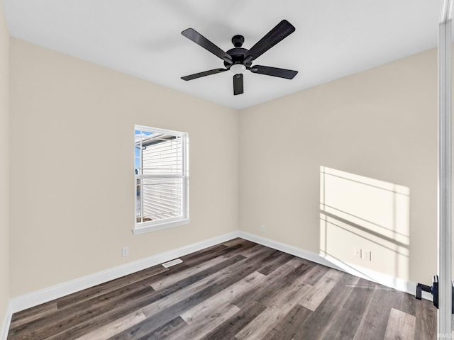 spare room with ceiling fan and dark hardwood / wood-style flooring