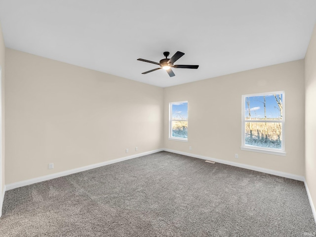 carpeted spare room with ceiling fan