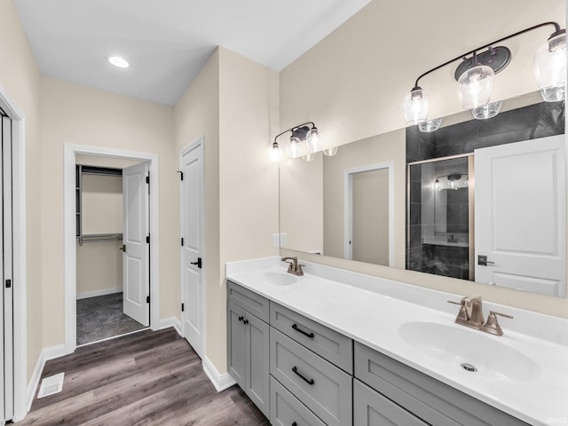 bathroom featuring vanity, hardwood / wood-style flooring, and walk in shower