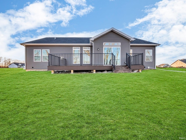 back of house featuring a yard and a deck