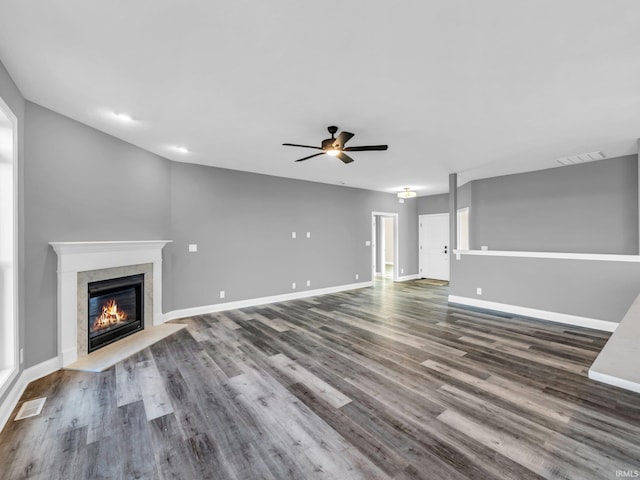 unfurnished living room with dark wood-type flooring and ceiling fan