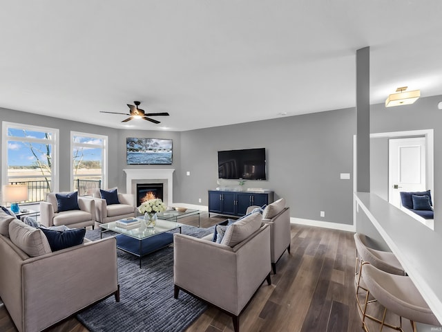 living room with ceiling fan and dark hardwood / wood-style floors