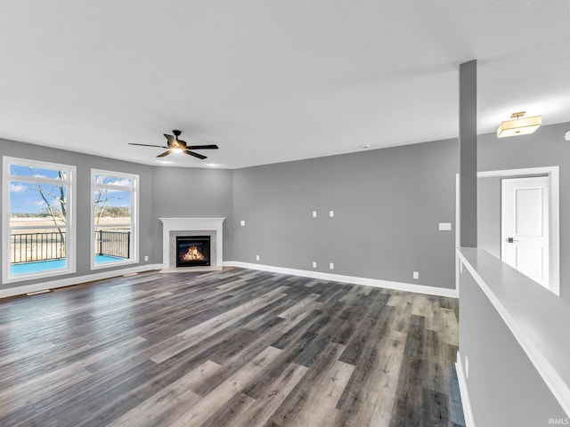 unfurnished living room featuring wood-type flooring and ceiling fan