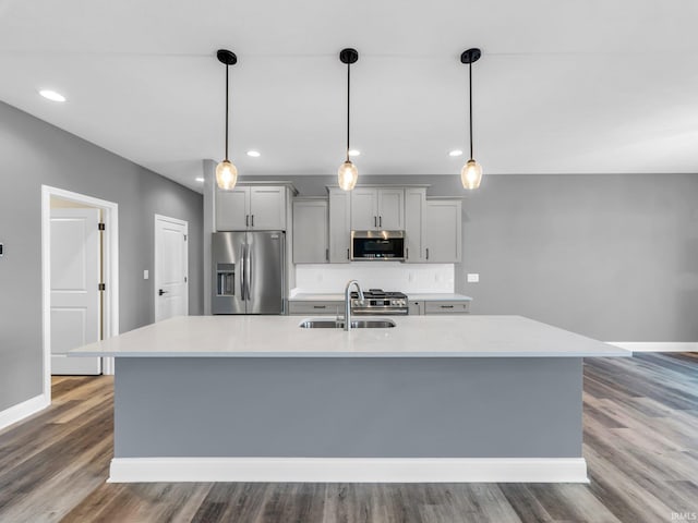 kitchen featuring gray cabinets, appliances with stainless steel finishes, sink, and pendant lighting