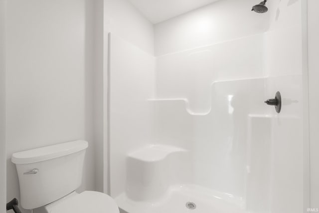 bathroom with toilet and walk in shower