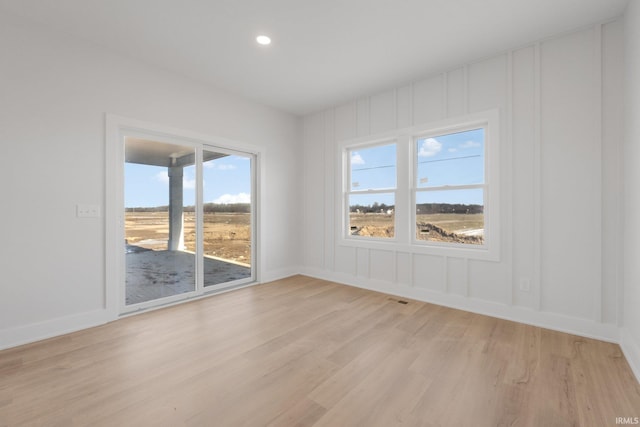 unfurnished room featuring light hardwood / wood-style floors